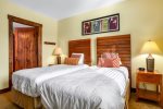 Two twin beds, with rustic wooden headboards